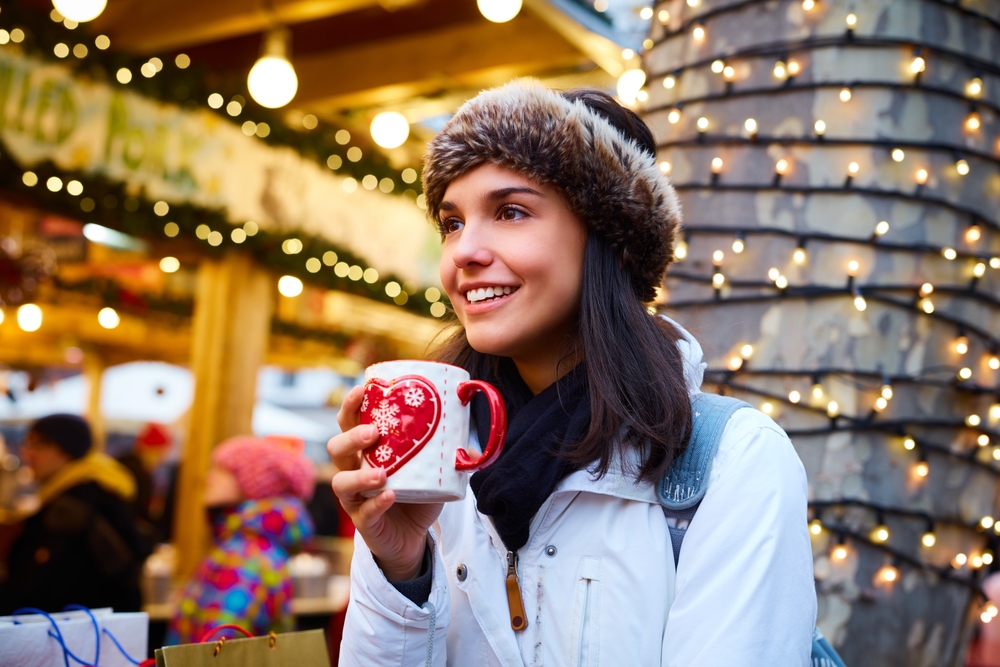 vrouw met beker op kerstmarkt